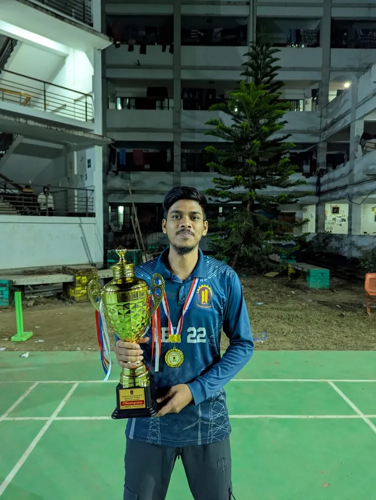 Holding the Champion trophy with a medal