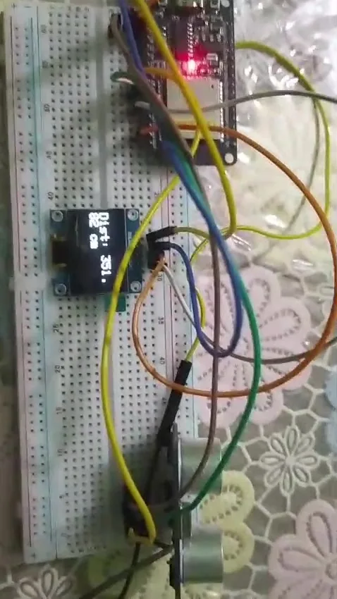 ESP-32 with ultrasonic sensor and OLED display on a breadboard