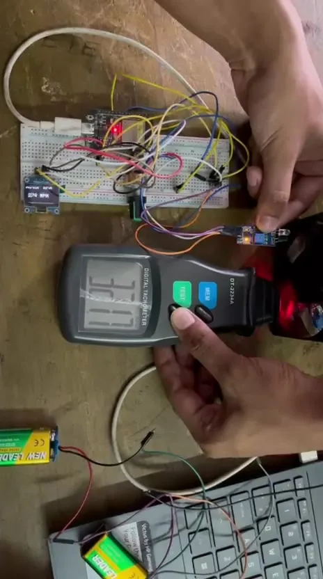 ESP-32 tachometer circuit beside a commercial digital tachometer