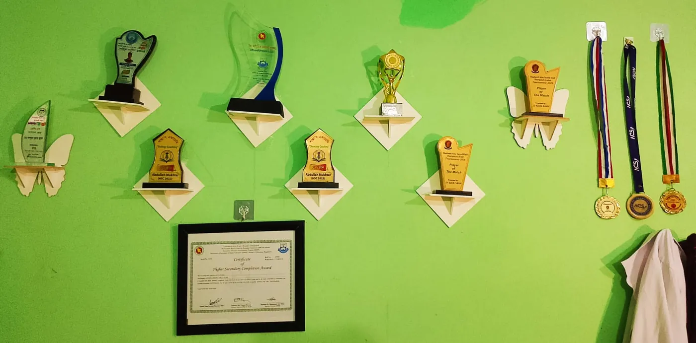 Wall shelf with trophies, certificate and medals